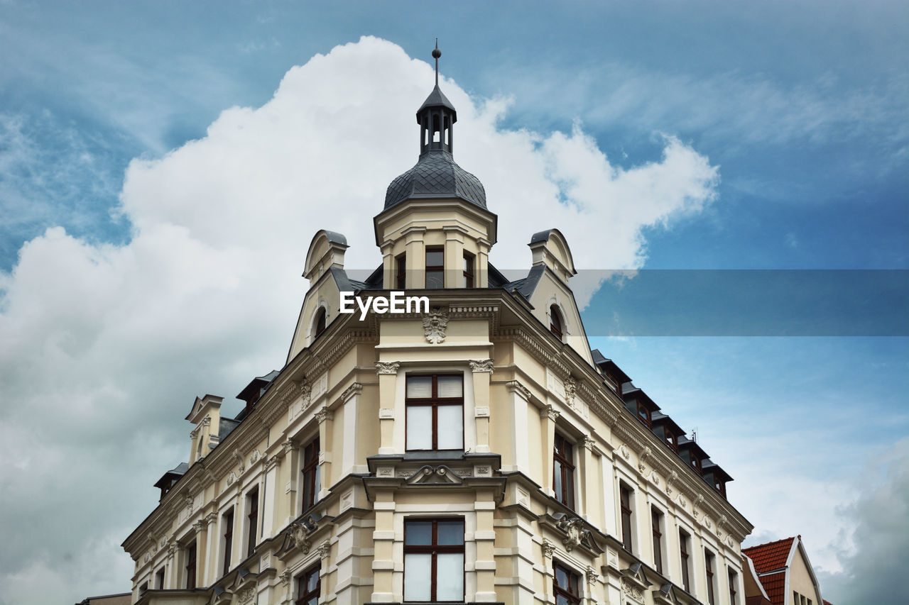 Low angle view of building against cloudy sky