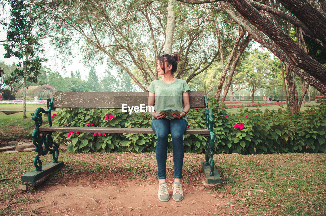 Woman sitting on park bench