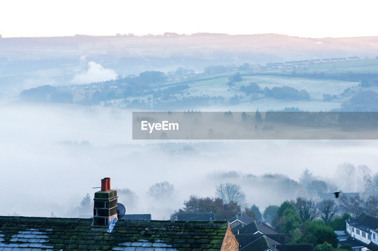 Scenic view of residential district against sky