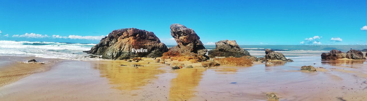 Panoramic view of beach against clear blue sky