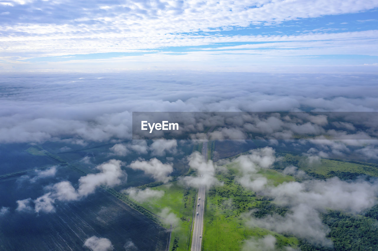 HIGH ANGLE VIEW OF CLOUDS OVER LANDSCAPE