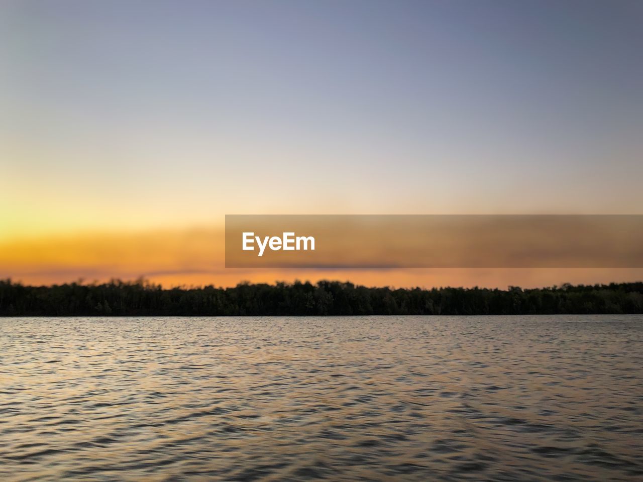 SCENIC VIEW OF LAKE DURING SUNSET