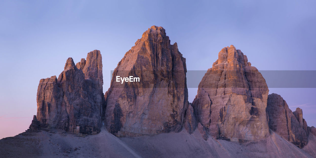 Three lavaredo peaks at sunrise with blue and purple sky -tre cime di lavaredo	