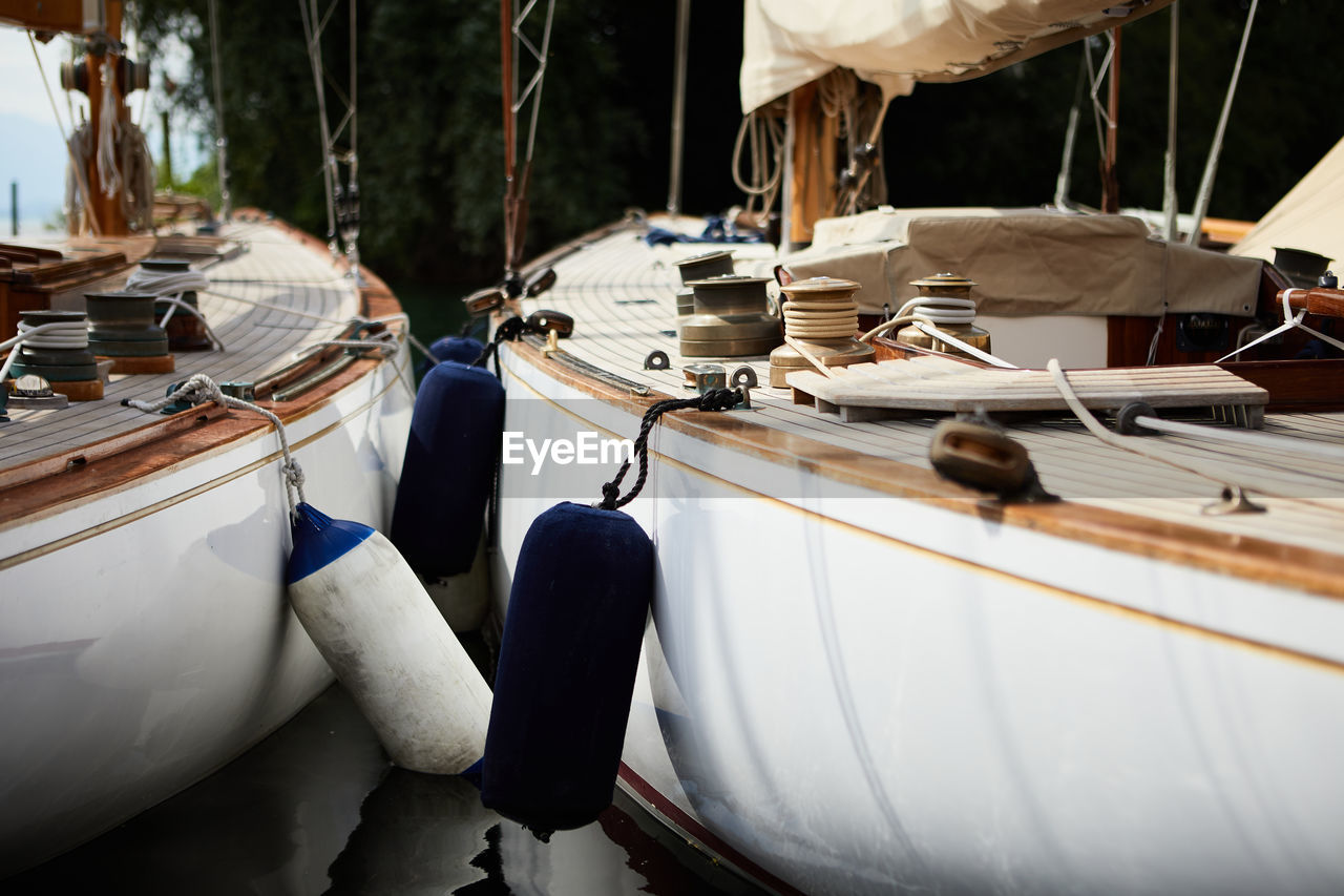 Close-up of boats moored in row