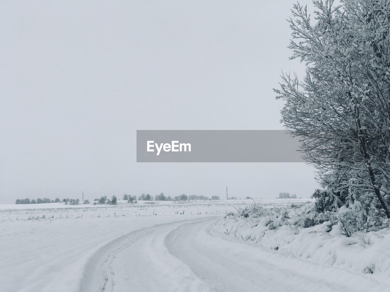 Snow covered field against sky