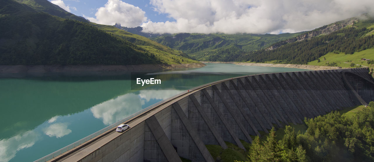 Scenic view of the dam and lake roseland by mountains against sky in the french alpes