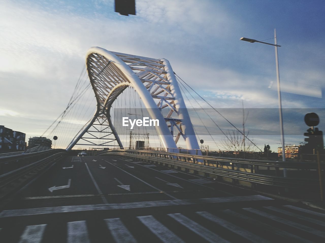 View of suspension bridge against cloudy sky