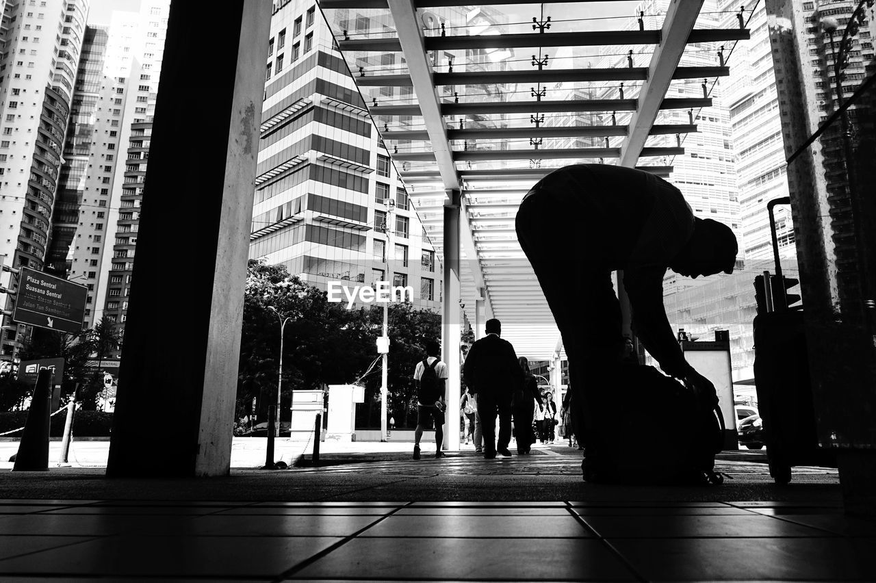 Silhouette people walking in modern office building