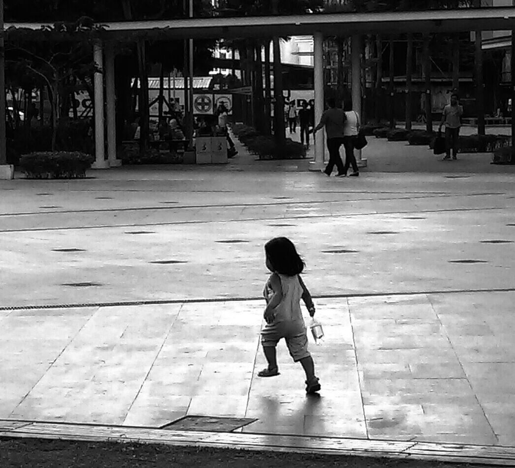 Full length of girl walking on sidewalk