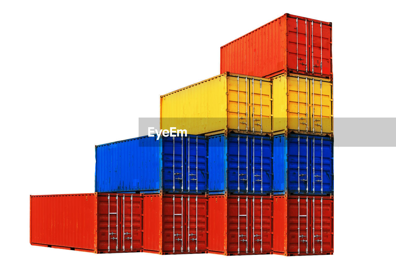 Stacked colorful cargo containers over white background