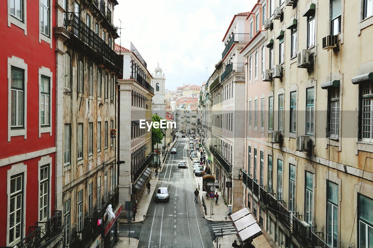 Street amidst residential buildings against sky