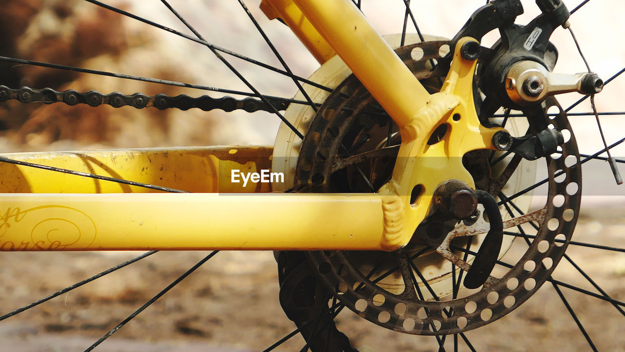Close-up of yellow bicycle wheel