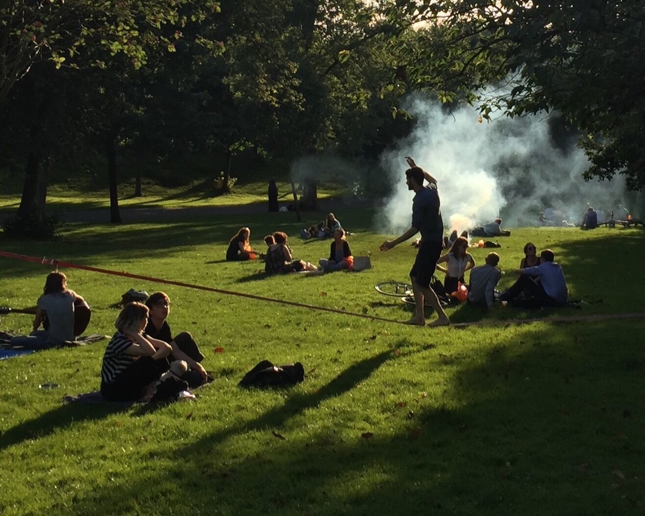 GROUP OF PEOPLE RELAXING ON GRASSLAND