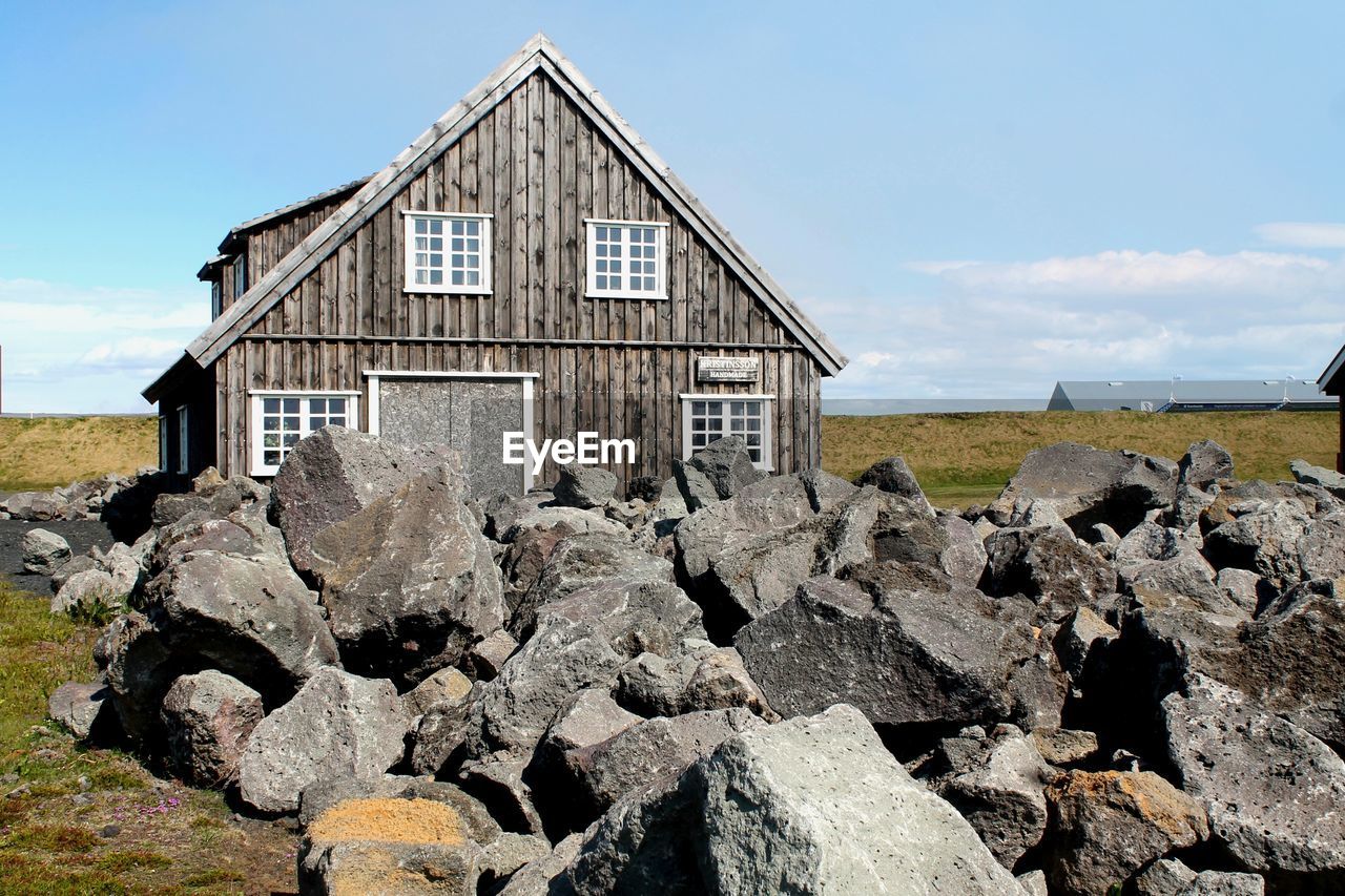 Built structure and big rocks on field in the icelandic city of grindavik.