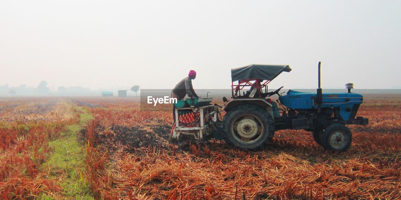MAN WORKING AT FARM