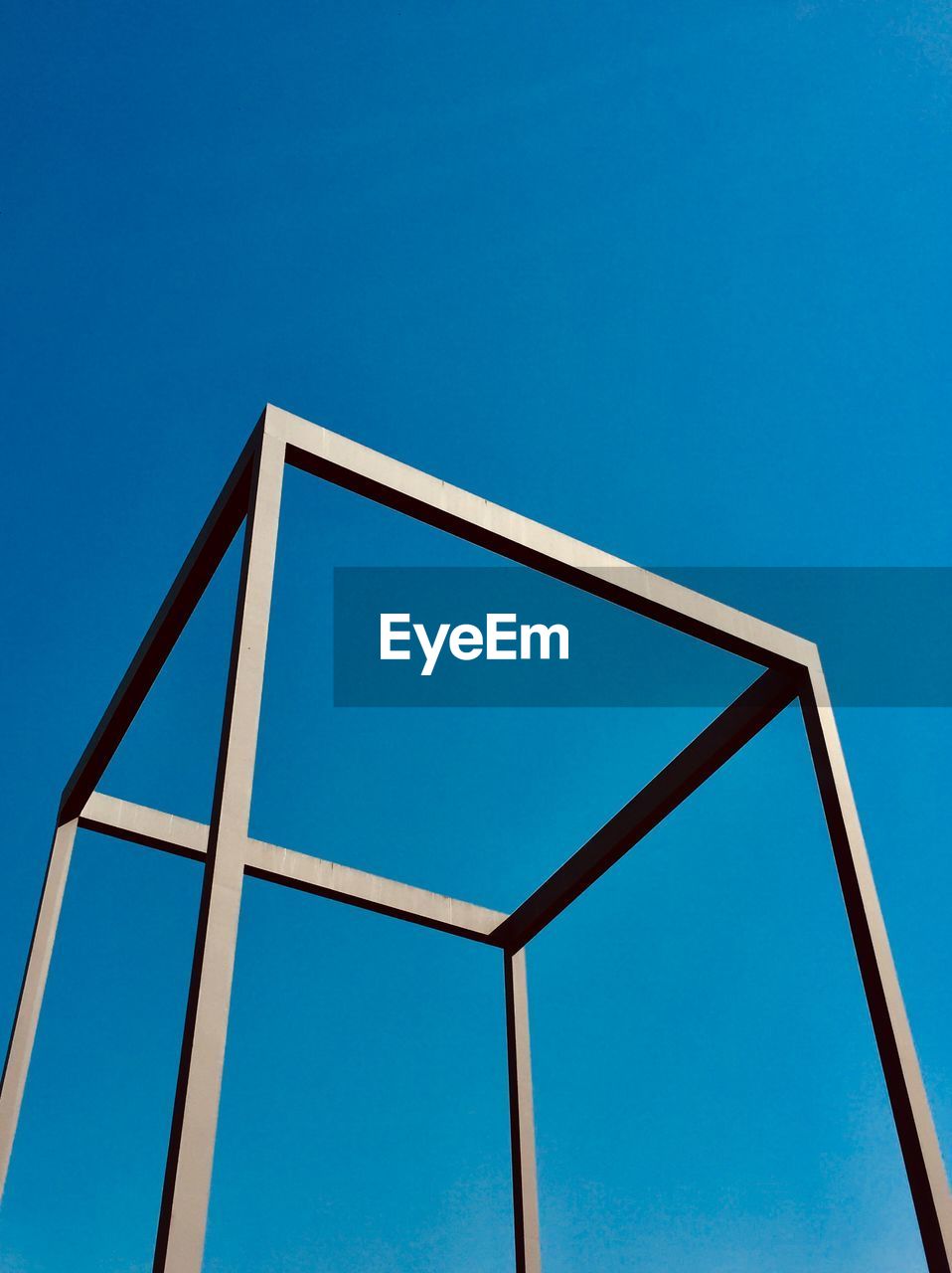 Low angle view of metal structure against clear blue sky