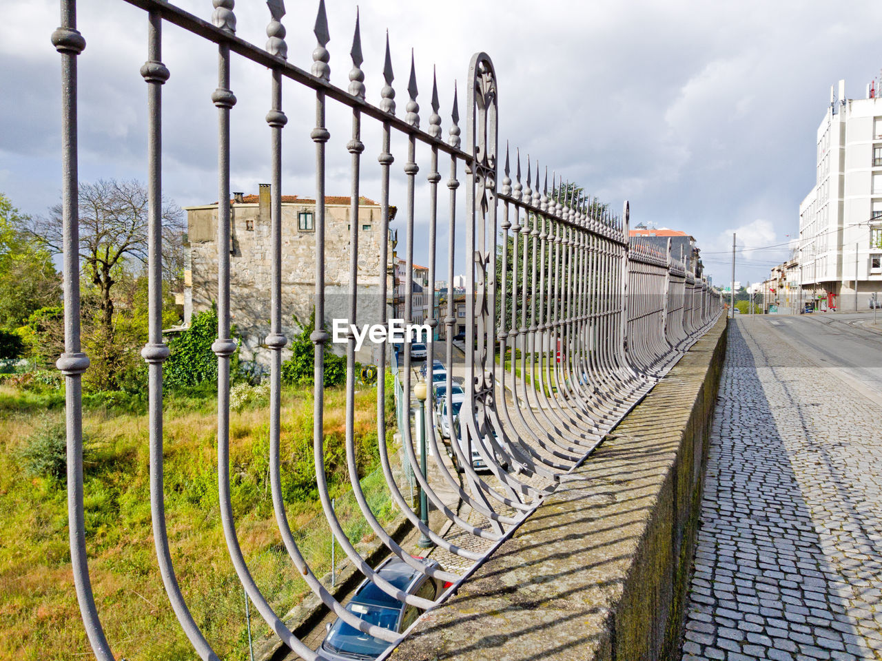 FOOTPATH AMIDST RAILING AGAINST SKY