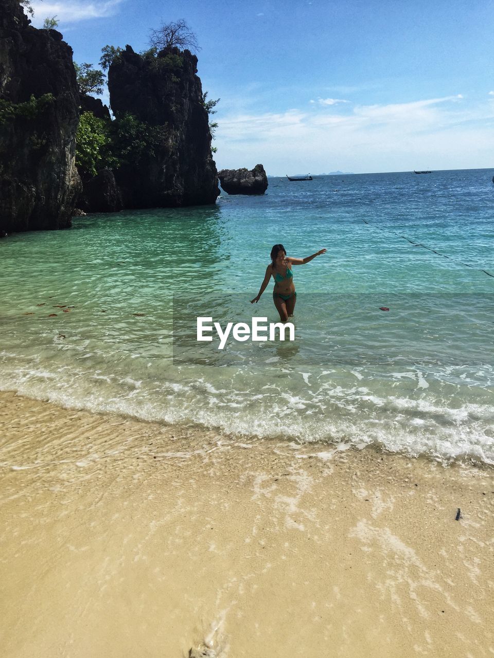 Woman in sea against sky