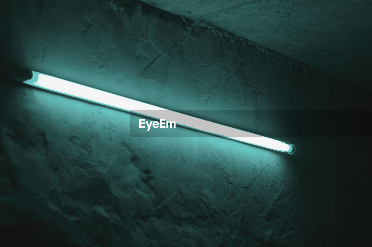 Low angle view of illuminated fluorescent light