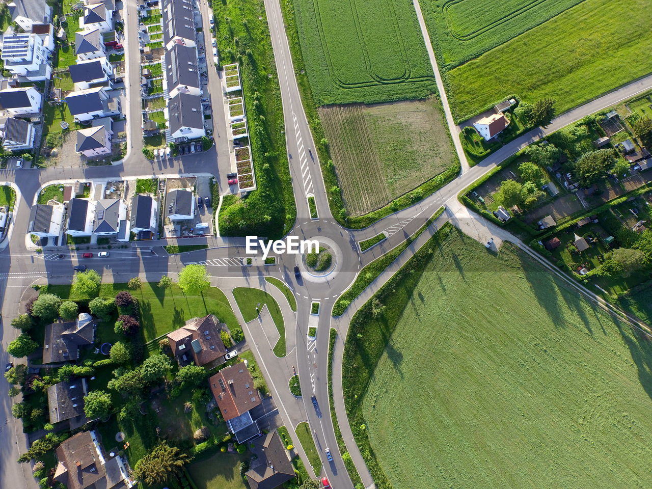 Aerial view of houses by agricultural field