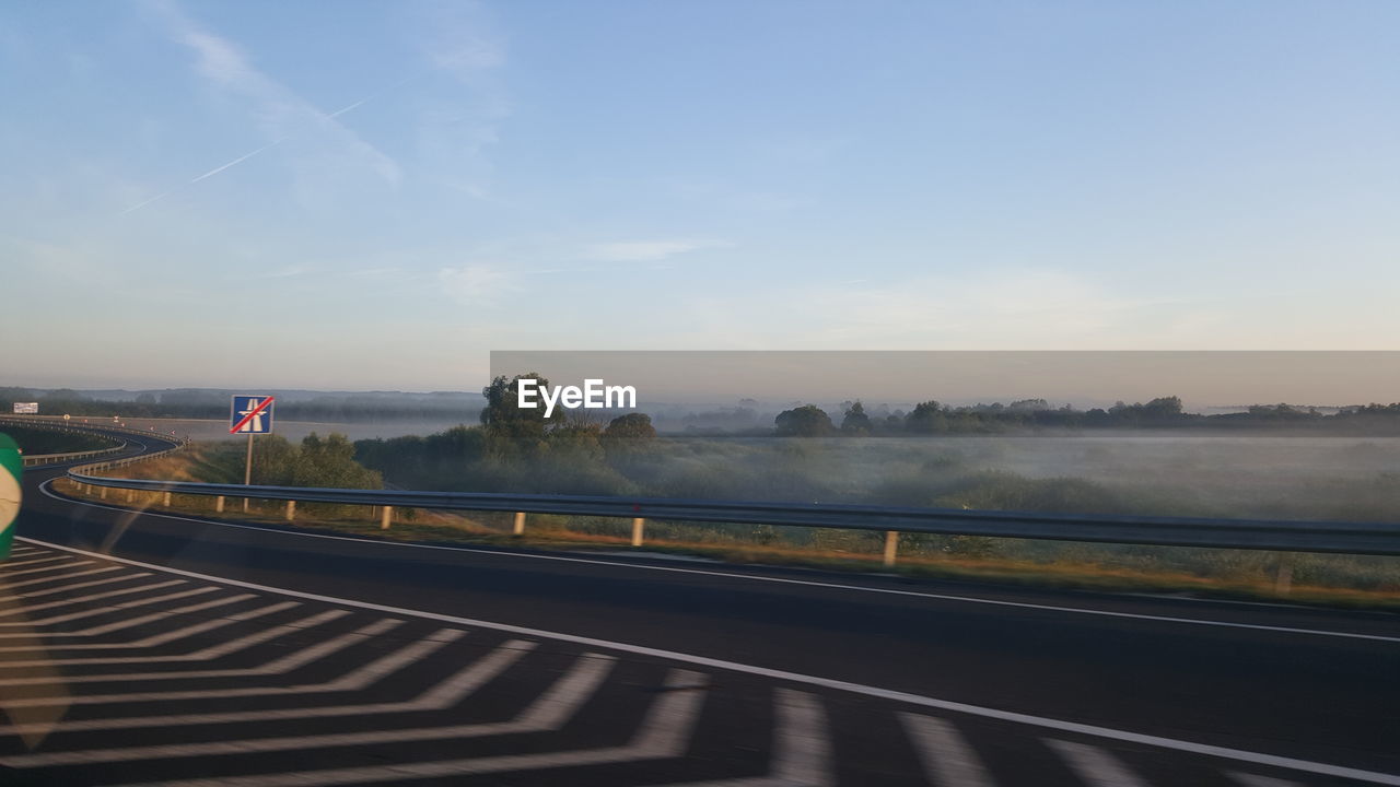 Scenic view of highway on field against sky