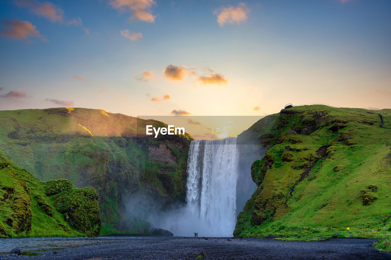 Scenic view of waterfall against sky