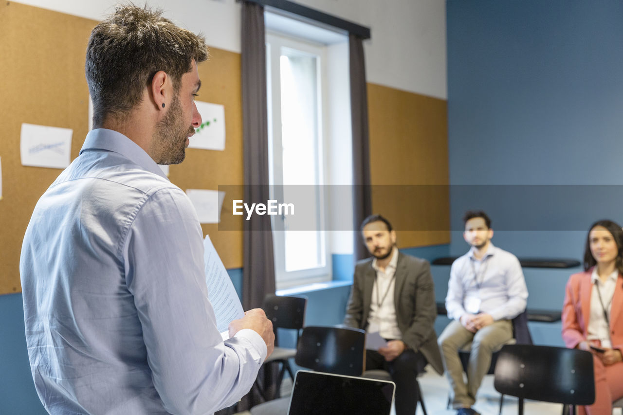 Businessman explaining business strategy to colleagues in office meeting