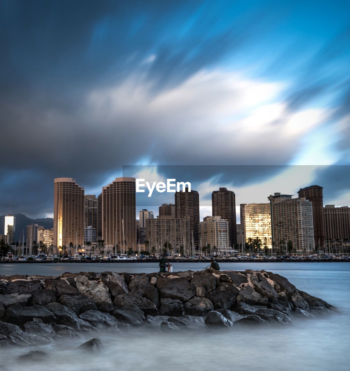 River with buildings against clouds