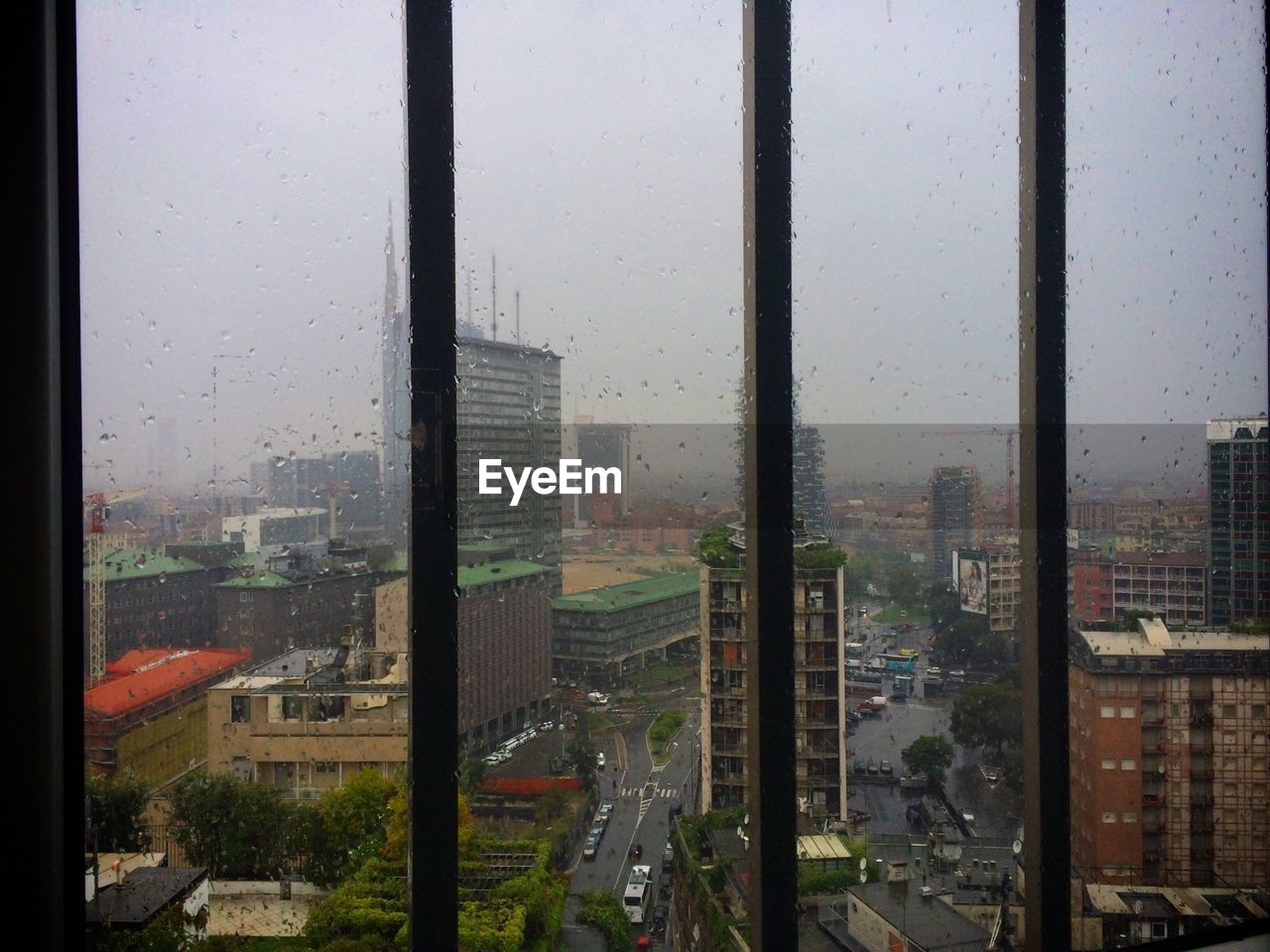 VIEW OF CITYSCAPE THROUGH WINDOW