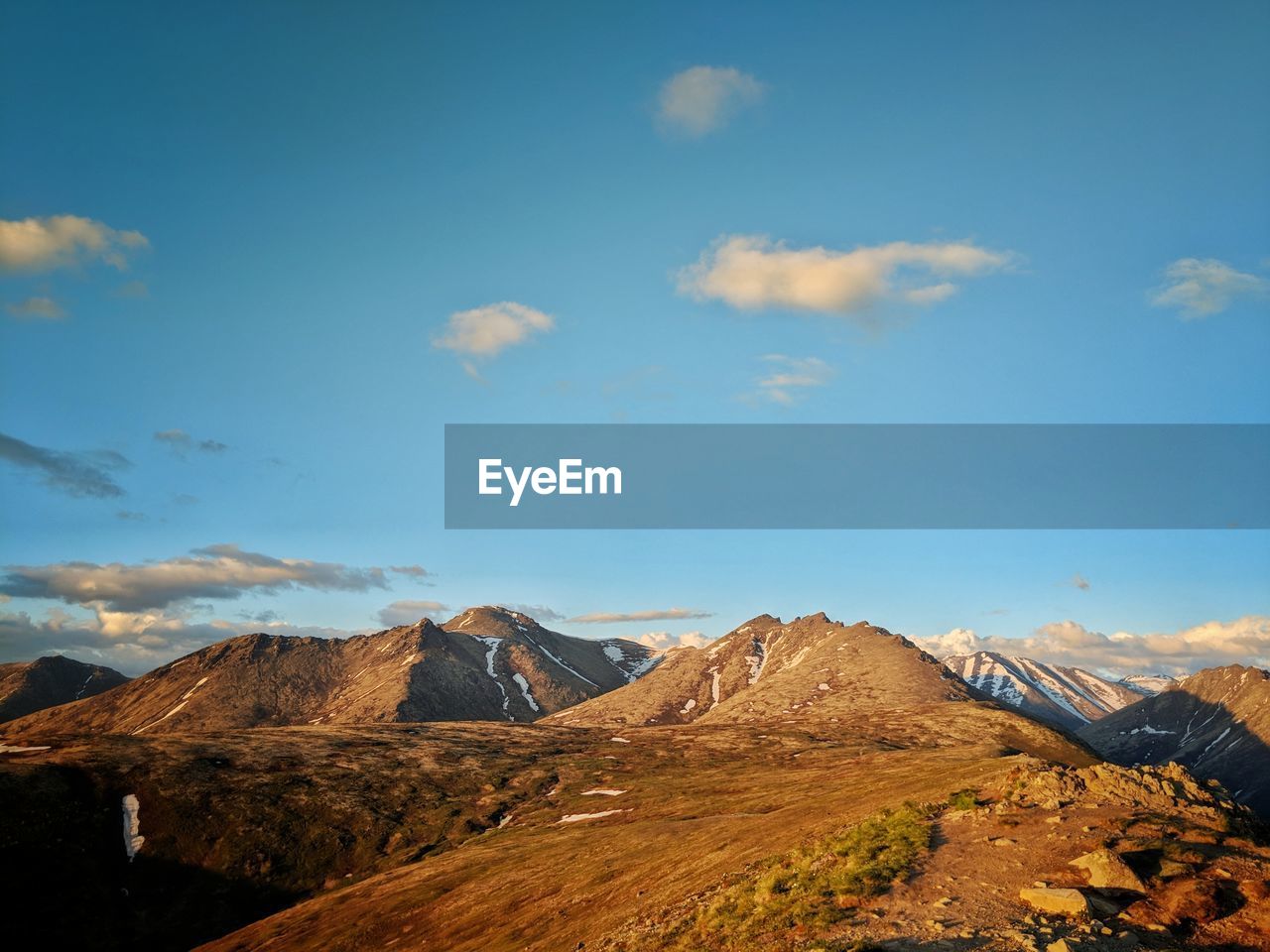 Scenic view of mountains against blue sky