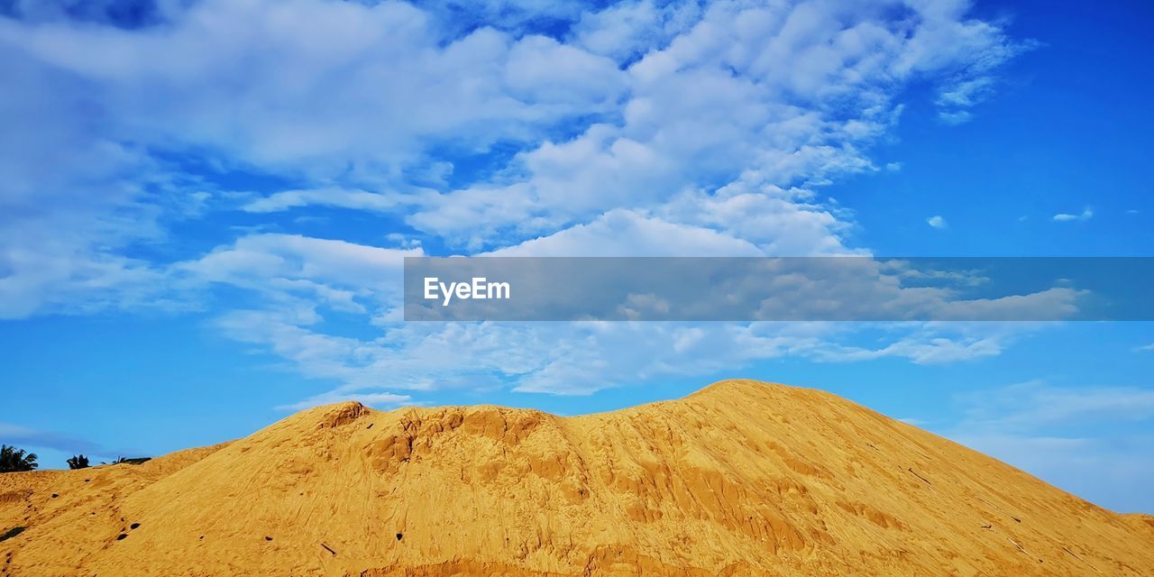 Low angle view of arid landscape against sky