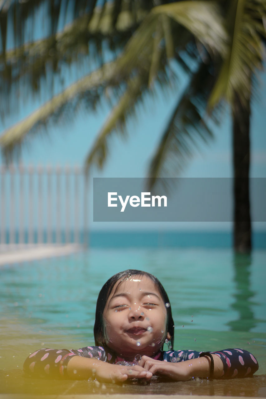 Cute girl swimming in pool