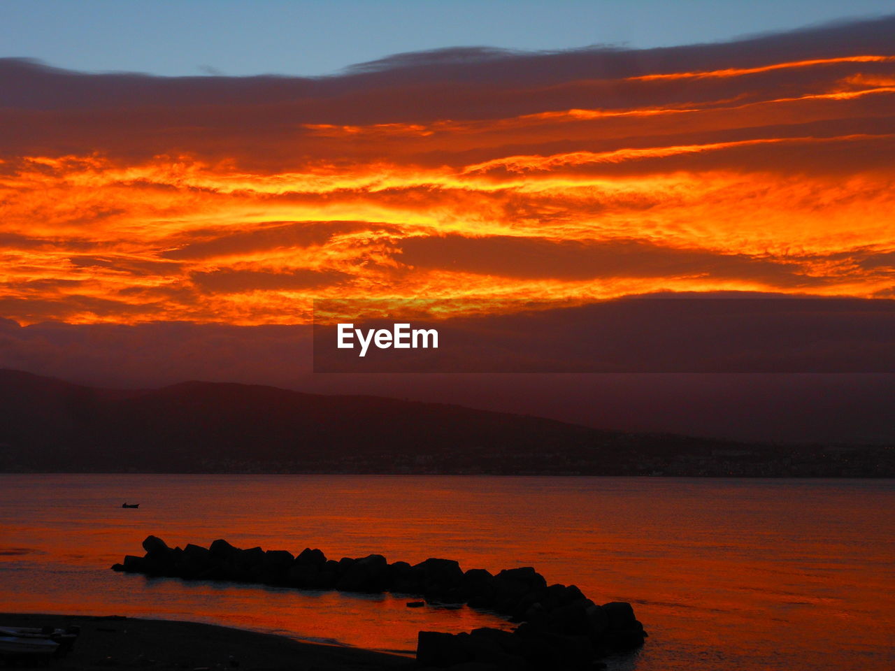 SCENIC VIEW OF SEA AGAINST ORANGE SKY