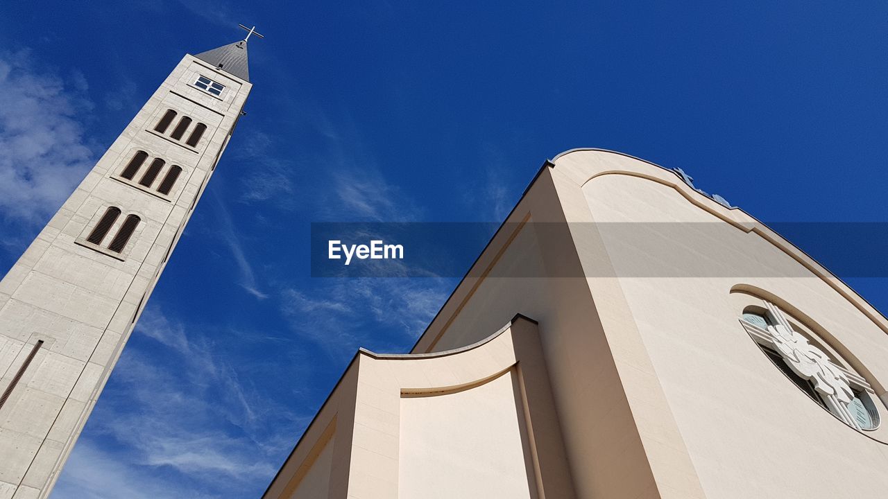 LOW ANGLE VIEW OF MOSQUE AGAINST BLUE SKY