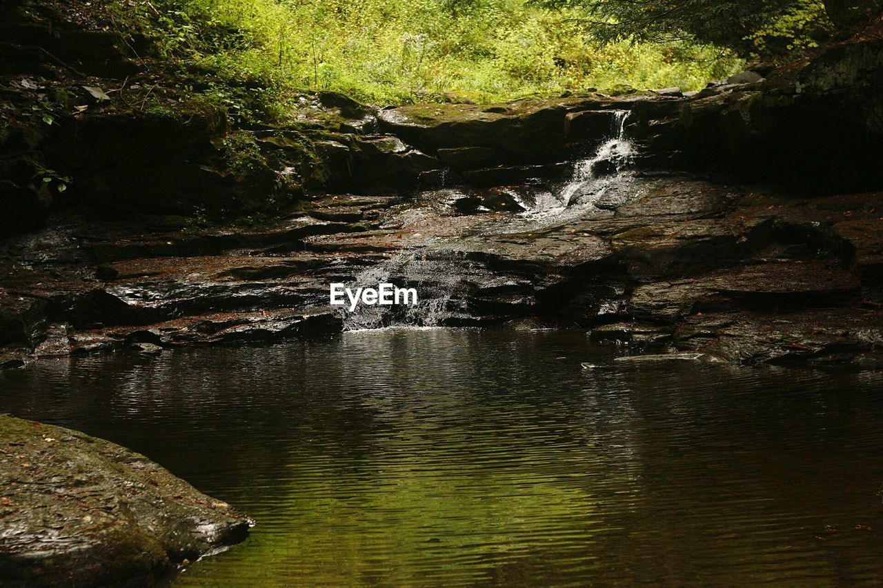 SCENIC VIEW OF RIVER FLOWING THROUGH ROCKS