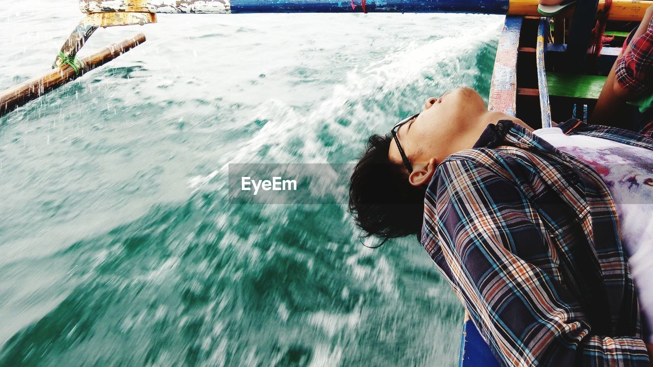 Man enjoying while traveling on boat in sea