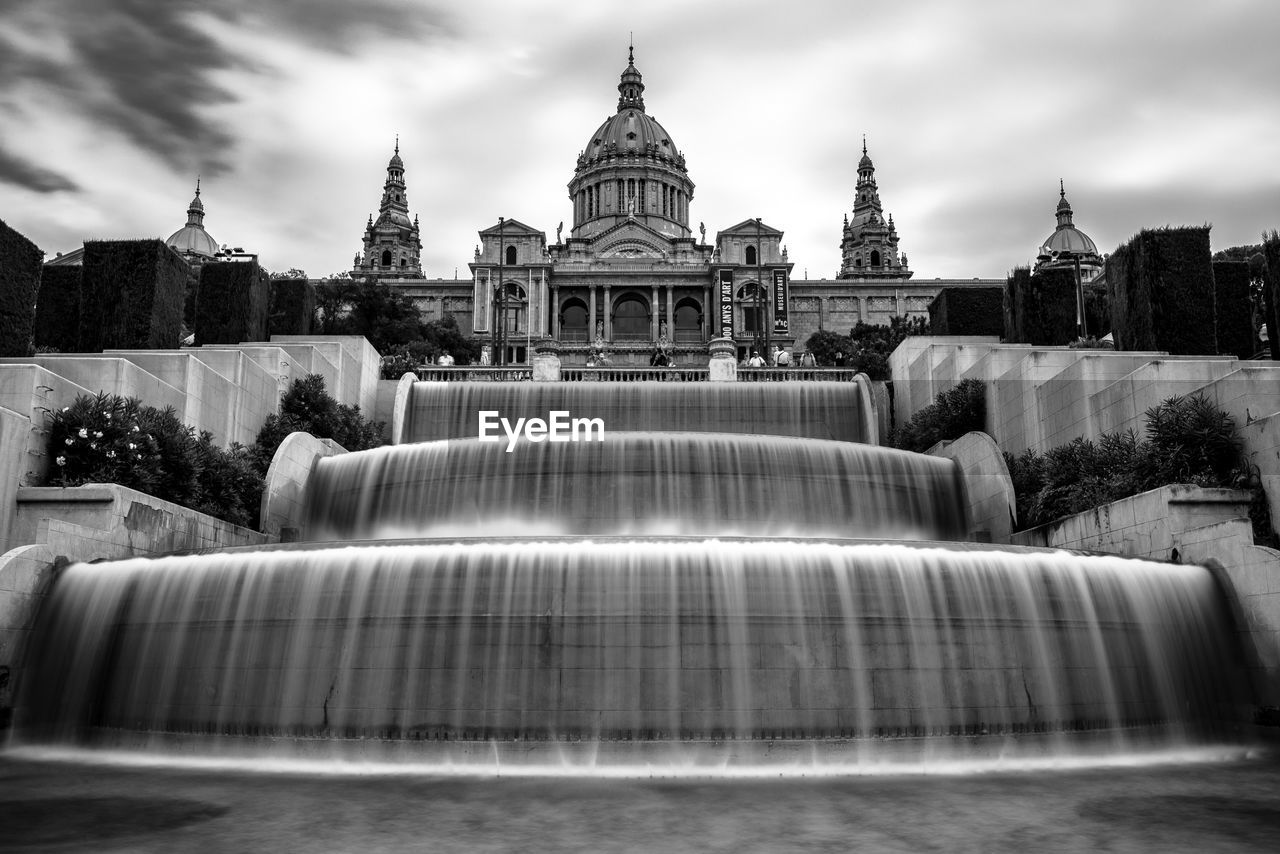 FOUNTAIN IN CITY AGAINST SKY