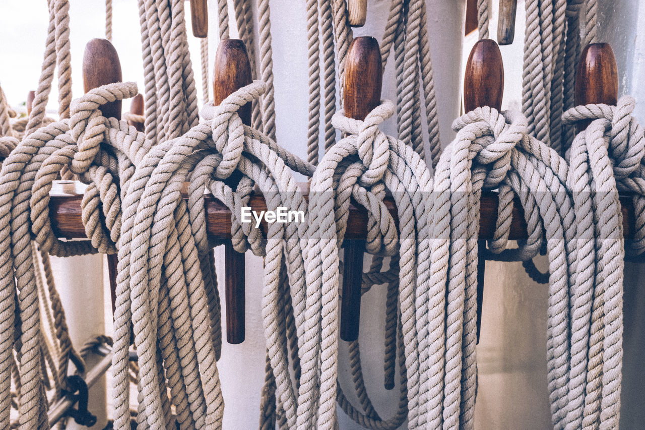 Close-up of rope tied to wood on boat deck
