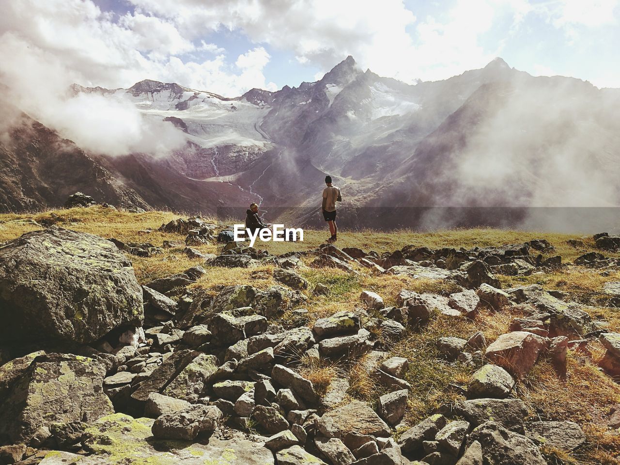 Rear view of hikers on mountain during foggy weather