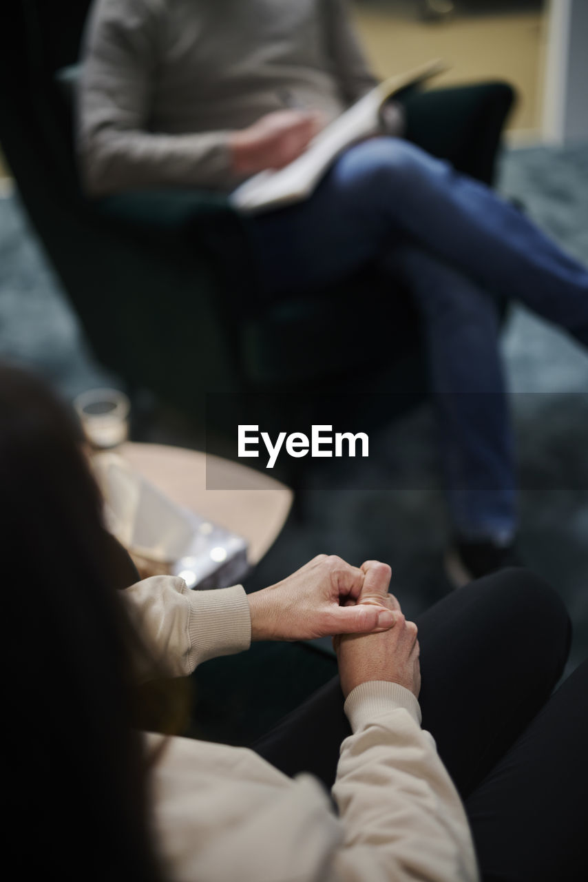 Female patient wringing hands at therapy session