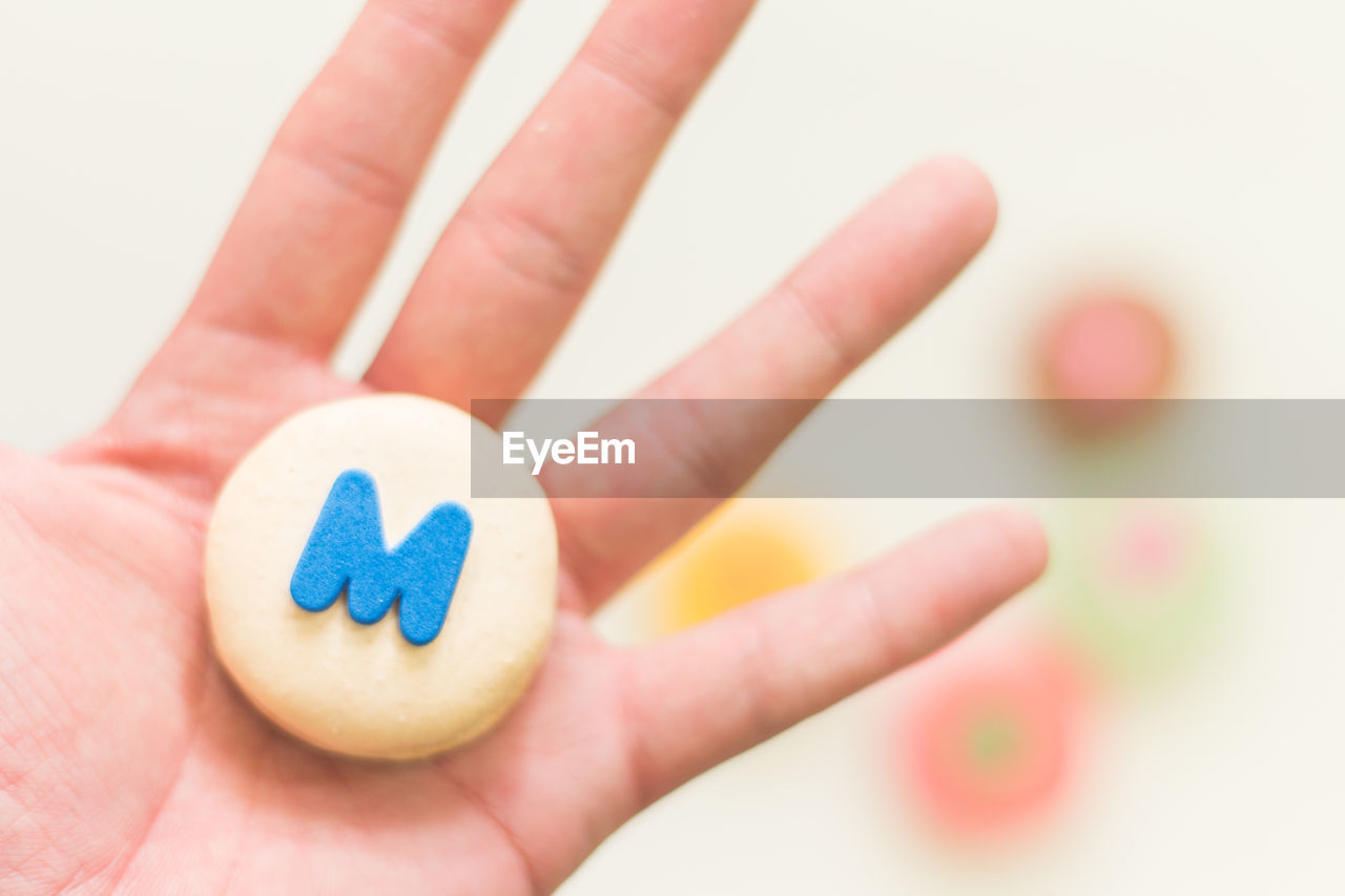 CLOSE-UP OF HAND HOLDING HEART SHAPE MADE OF HUMAN EYE