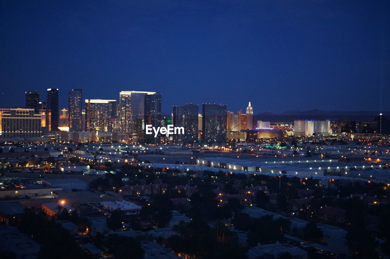 ILLUMINATED CITYSCAPE AT NIGHT