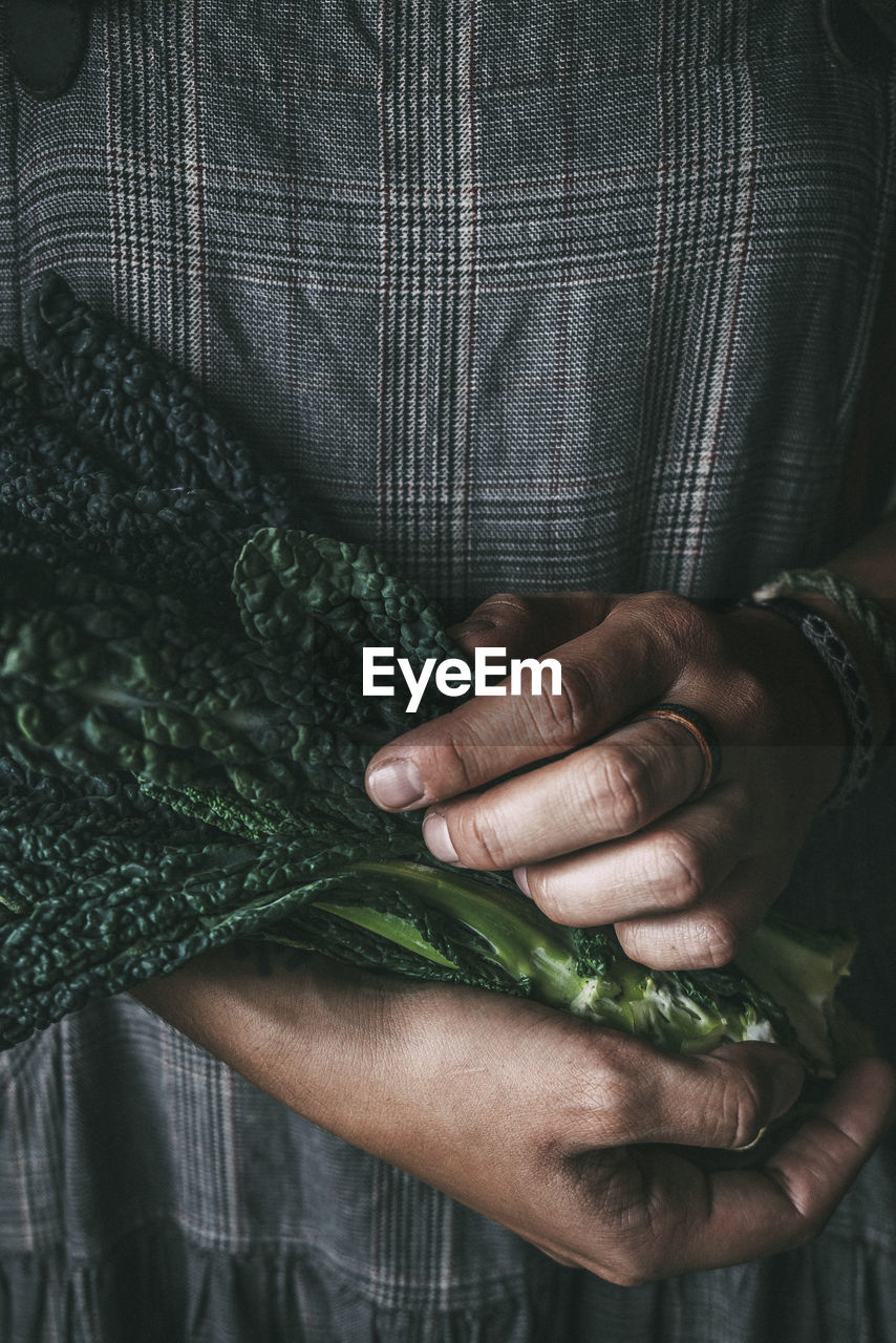 Person holding kale leaves