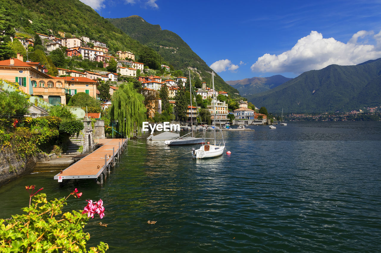 Boats in river against built structures