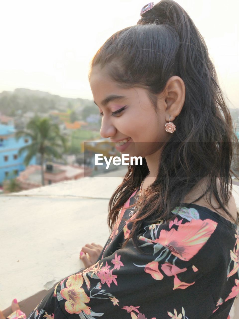 Close-up of smiling young woman looking down