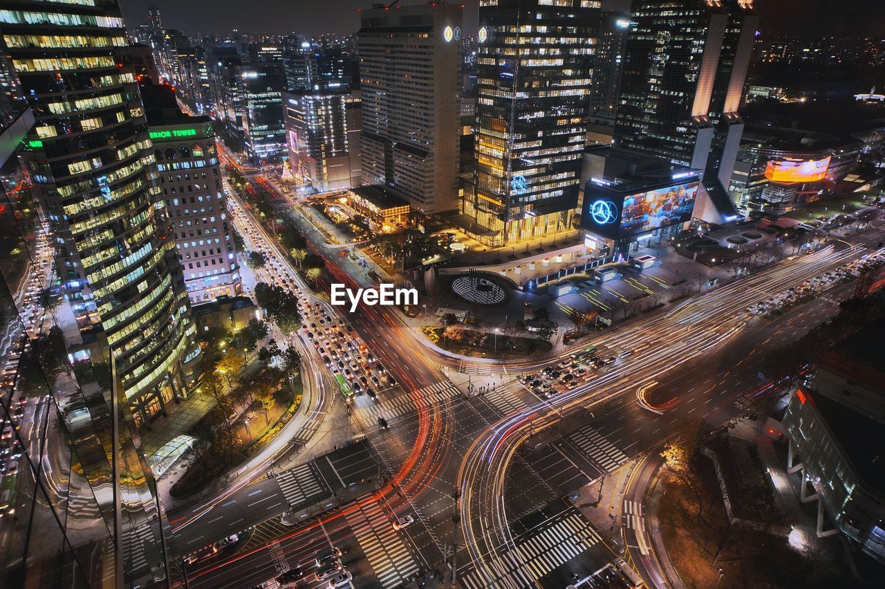 High angle view of crossroad in illuminated city at night