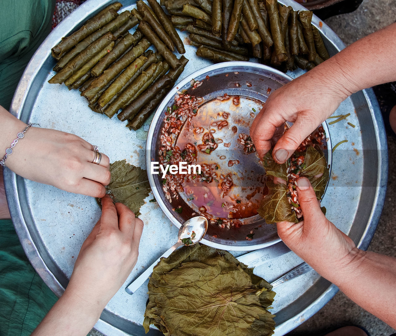 HIGH ANGLE VIEW OF HANDS HOLDING FOOD