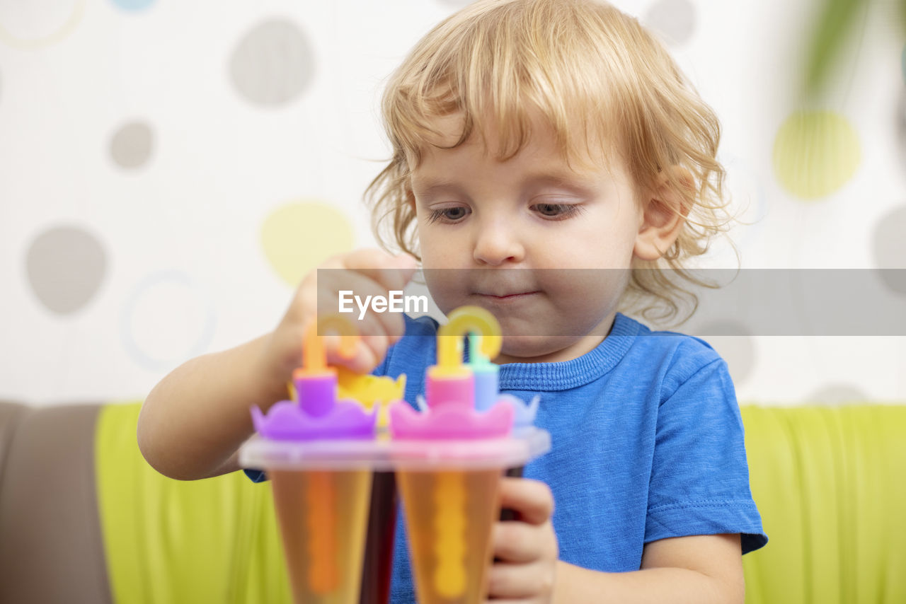 portrait of cute girl blowing toy