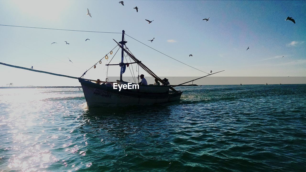 SILHOUETTE OF SHIP IN SEA AGAINST CLEAR SKY