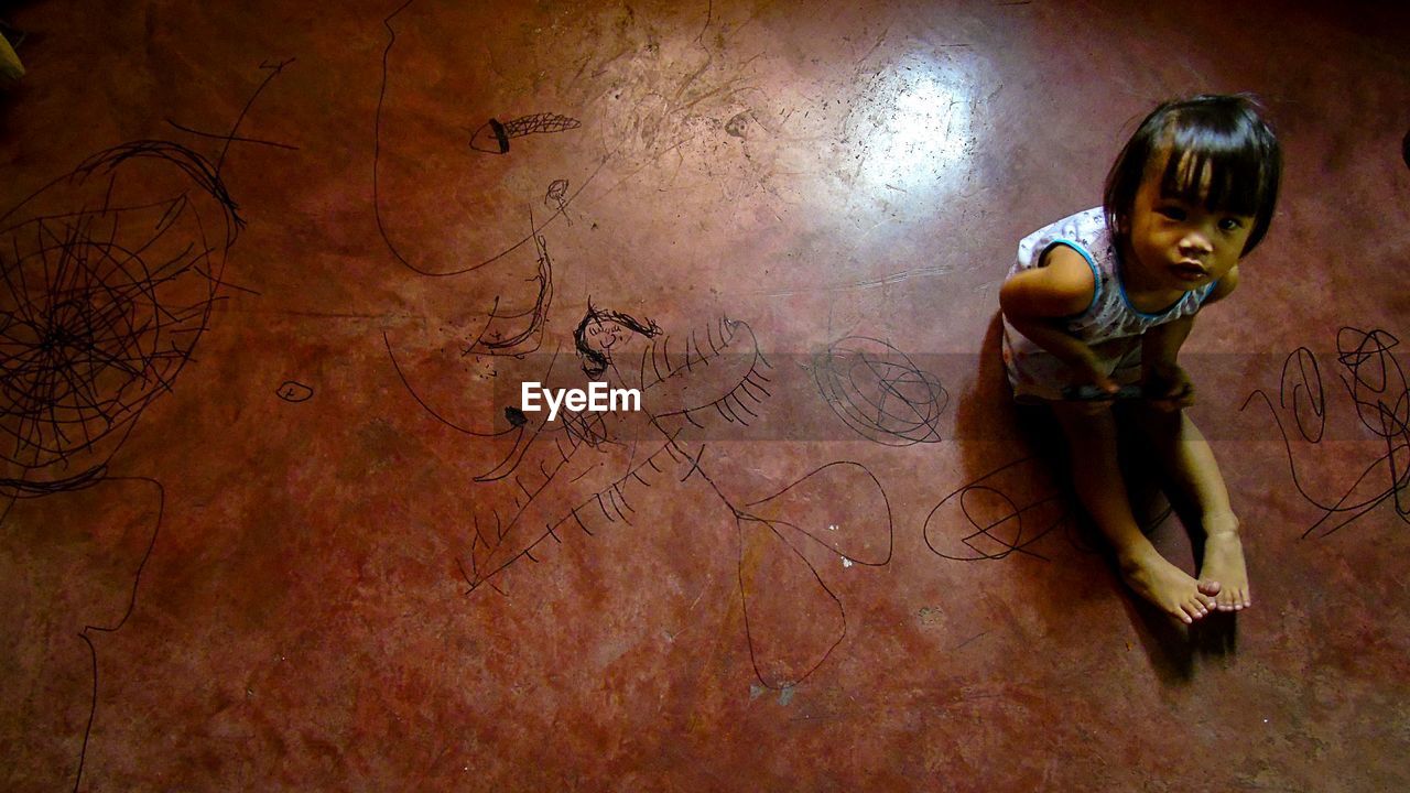 Portrait of girl sitting on floor